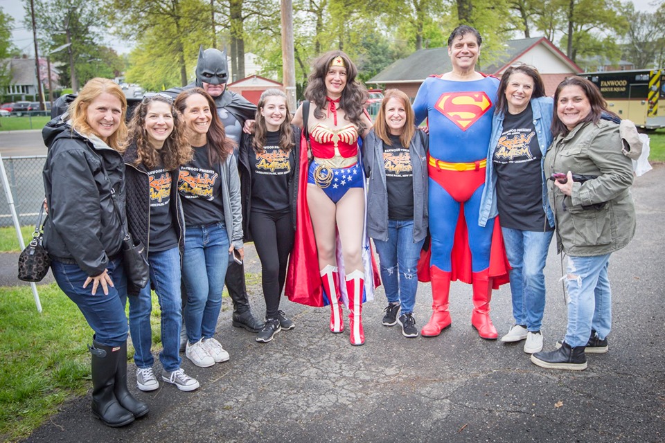 Rockin' for Autism volunteers with Batman, Wonder Woman, and Superman